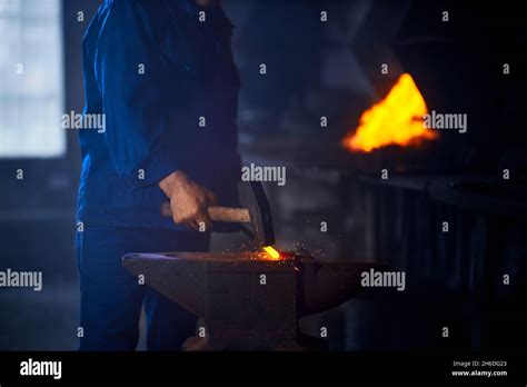 Close Up Of Blacksmith Hands Hitting With Hammer On Glowing Hot Metal Man Processing Metal On
