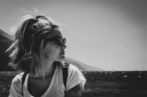 Premium Photo Close Up Of Woman Wearing Sunglasses Sitting Against Clear Sky