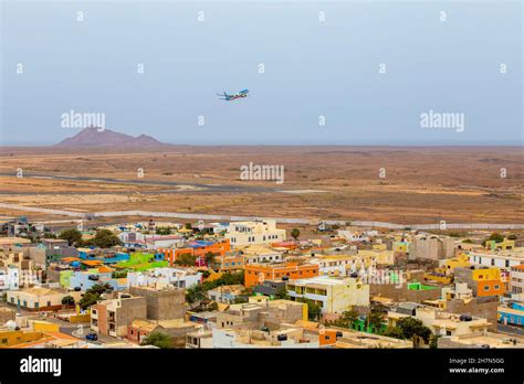 Plane Takes Off In Front Colourful Houses Of Espargos Sal Airport