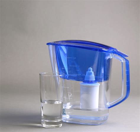 premium photo water filter jug   glass   grey background