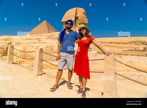 A Tourist Couple At The Great Sphinx Of Giza On The Background Of The Pyramids Of Giza Cairo