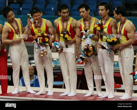 Chinese Men S Gymnastic Team Celebrates On The Podium After Being Awarded With The Gold Medal