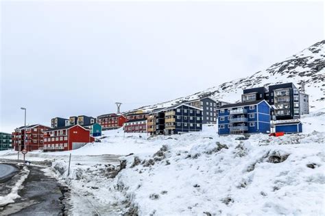 Premium Photo | Winter street and row of colorful inuit houses on the ...