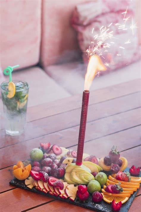 Birthday Celebration Firework Candle Set Inside Of An Exotic Fruit