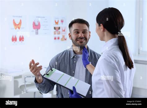 Endocrinologist Examining Thyroid Gland Of Patient At Hospital Stock