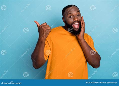 Photo Of Cool Impressed Guy Wear Orange T Shirt Pointing Thumb Up Empty