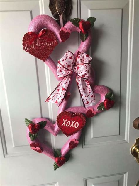 A Valentine S Day Wreath Hanging On The Front Door With Two Heart