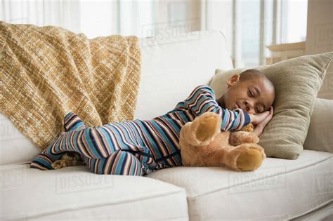 African American Boy Napping On Sofa Stock Photo Dissolve