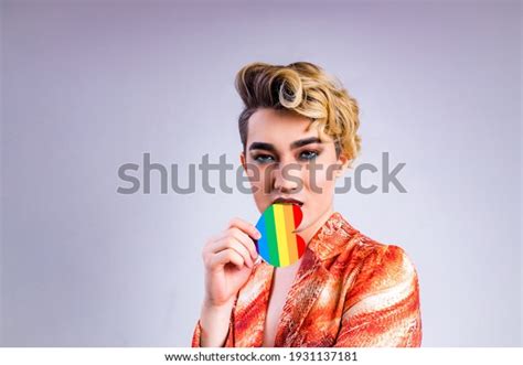 Non Binary Portrait Of Asian Man With Luxurious Blonde Hair And Gorgeous Make Up In White Wall