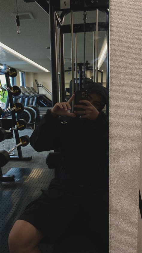 A Person Taking A Selfie In Front Of A Gym Machine With Their Cell Phone