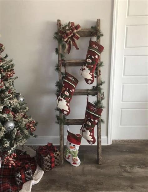 A Christmas Tree With Stockings Hanging From It Next To A Ladder