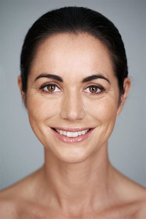 Confident Beauty Cropped Studio Portrait Of A Beautiful Mature Woman Smiling Stock Photo