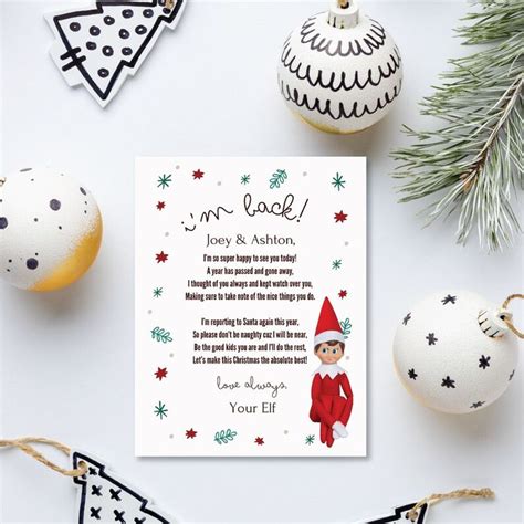 A Christmas Card With An Elf S Message On It Next To Ornaments And