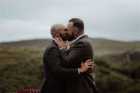 Two Men In Suits Are Embracing Each Other