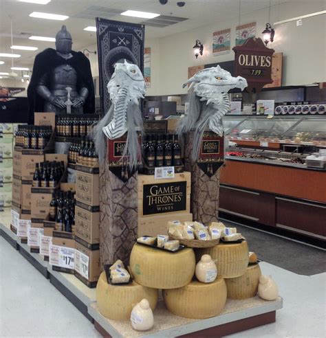 A Display In A Store Filled With Cheese And Wine