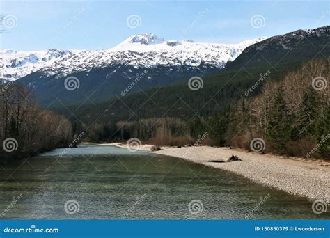 River in Dyea, Alaska with Snow Covered Mountains Stock Image - Image ...