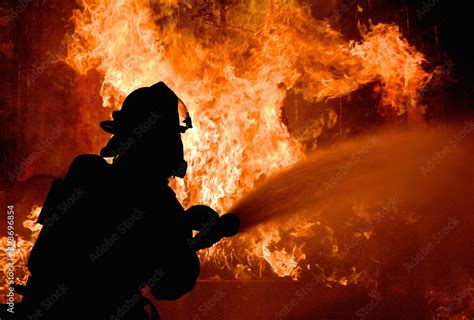 Foto De Silhouette Of Firemen Fighting A Raging Fire With Flames Forest Fire Do Stock Adobe