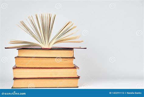 Stack Of Books And An Open Book With Yellow Pages Stock Image Image