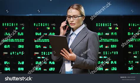 Beautiful Female Programmer Standing Server Room Stock Photo 1904129107