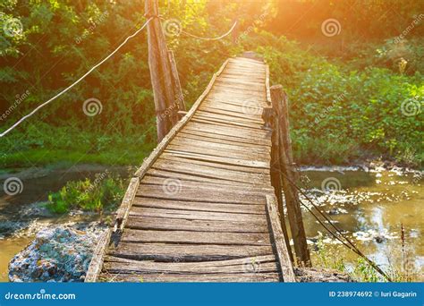 Old Wooden Footbridge Across The River Background With Copy Space