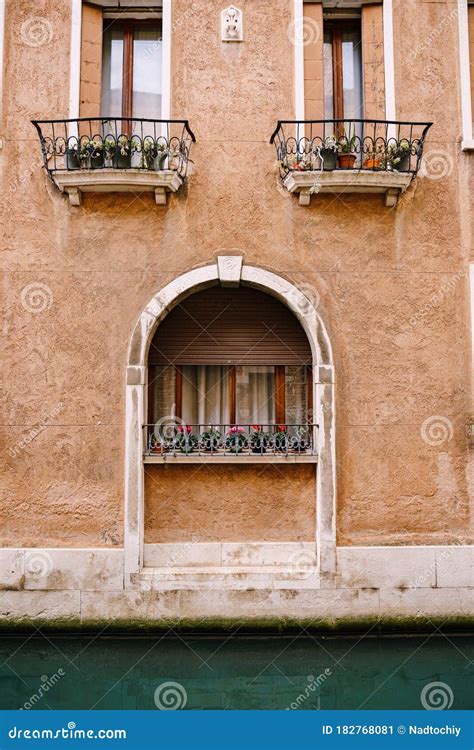 Close Ups Of Building Facades In Venice Italy A Stone Arch Above A