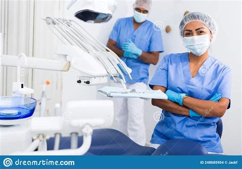 Professional Woman Dentist With Arms Crossed At Dental Clinic Stock