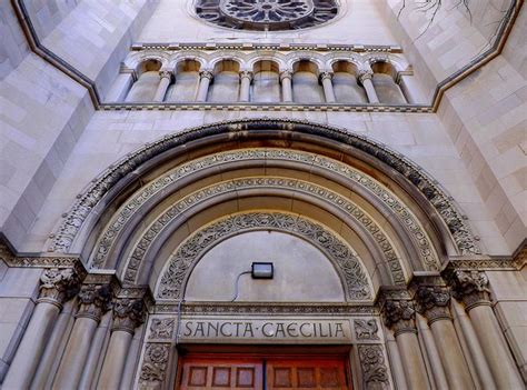 The Front Entrance To Santa Cecilia Church With An Arched Doorway And