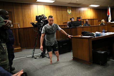 Paralympic Gold Medalist Oscar Pistorius Walks Across The Courtroom