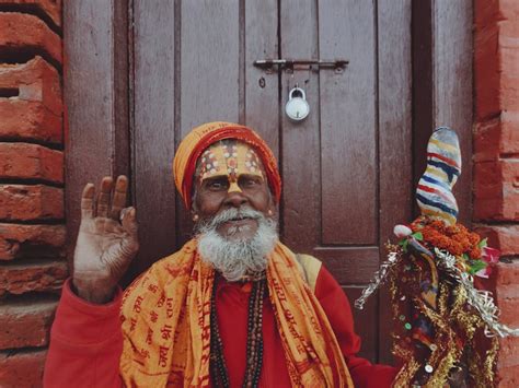 Smiling Sadhu By Wooden Door · Free Stock Photo