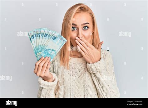 Beautiful Caucasian Blonde Woman Holding Brazilian Real Banknotes