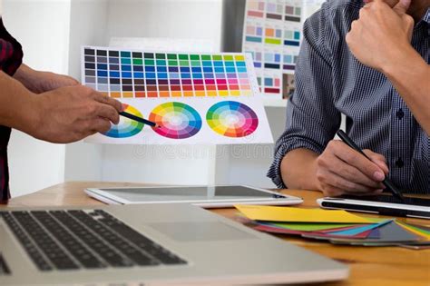 Graphic Designers Choose Colors From The Color Bands Samples For Design