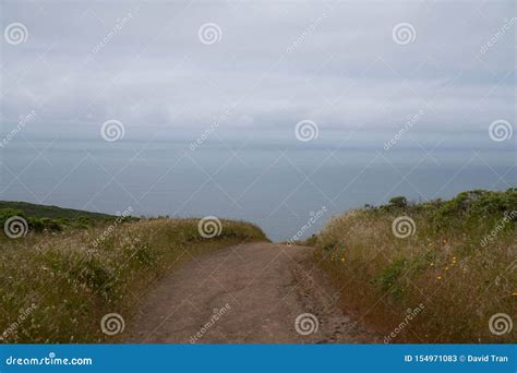 Dirt Path Dipping Below View Leading To Ocean Water Sense Of Unknown