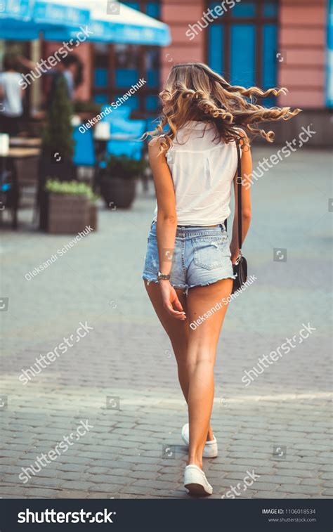 Beautiful Girl Walking Down The Street