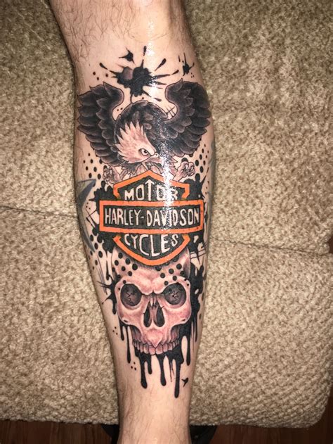 A Man S Leg With Tattoos On It And A Harley Davidson Motorcycle Logo