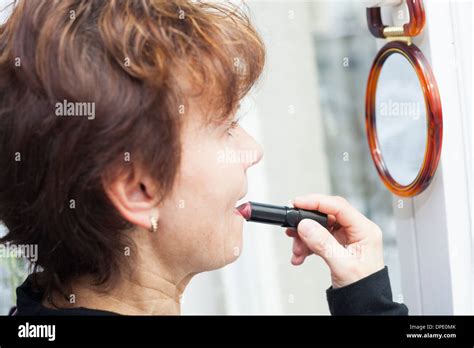 Mature Woman Applying Lipstick Hi Res Stock Photography And Images Alamy