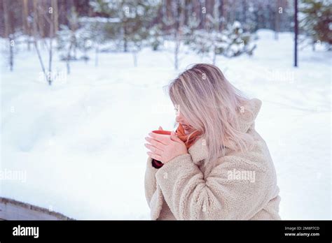 Woman Drinking Hot Drink From A Mug Stock Photo Alamy