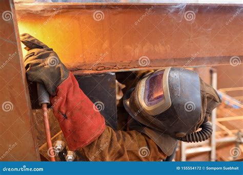 Macro Pic Of Maintenance Welder Wearing Red Safety Glove Welding Helmet