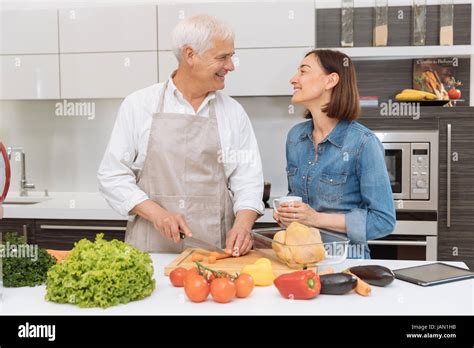 Mature Couple Cooking Meal At Home Stock Photo Alamy