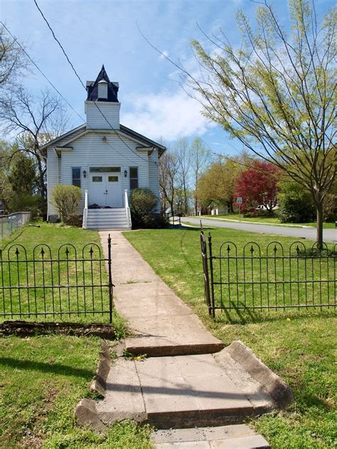 An Old Church With A Steeple And Gate