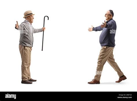 Full Length Profile Shot Of A Mature Man Walking Towards An Elderly