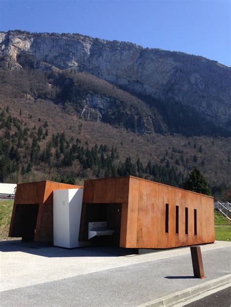 A Large Wooden Structure Sitting On The Side Of A Road In Front Of A