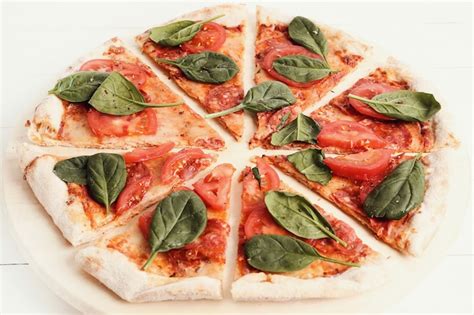 Free Photo Traditional Pizza With Tomato Slices And Basil Leaves