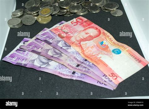 100 and 50 Philippine peso bills and Philippine peso coins Stock Photo - Alamy