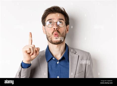 Excited Handsome Man In Glasses And Business Suit Look Up And Pointing