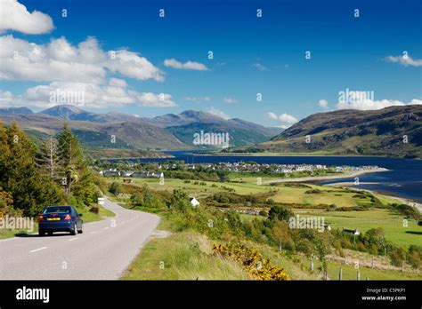 Car On The The A835 Main Road With View Over Ullapool And Loch Broom