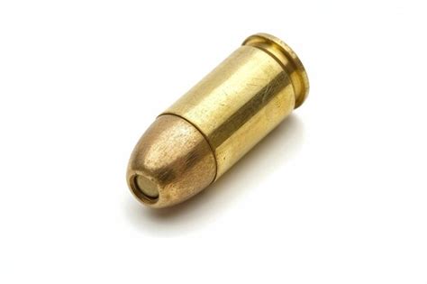 Premium Photo A Brass Bullet On A White Background