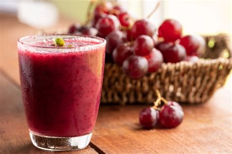 Premium Photo | Glass of grape juice smoothie on wooden table