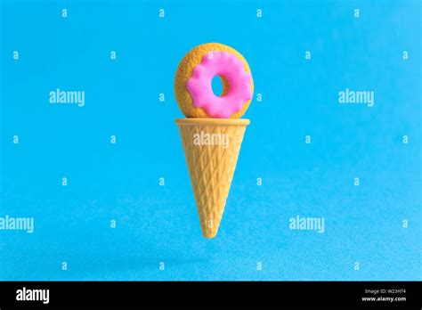 Doughnut In Ice Cream Cone Against Blue Background Minimal Sweet Food