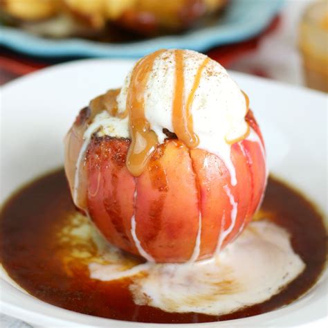 An Apple Covered In Ice Cream And Caramel Sauce On A Plate With Other