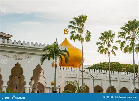 Masjid At Taqwa Mosque With Its Golden Dome And Palm Trees Miri City